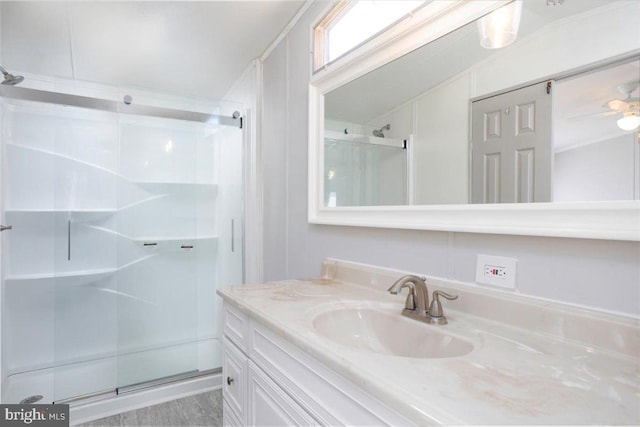 full bath with a stall shower and vanity