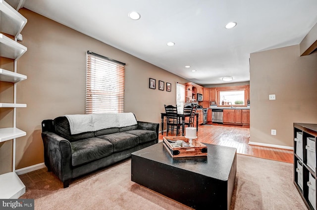 living room featuring recessed lighting, light wood-style flooring, and baseboards