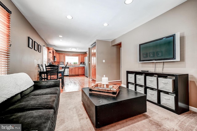 living room with baseboards, light colored carpet, and recessed lighting