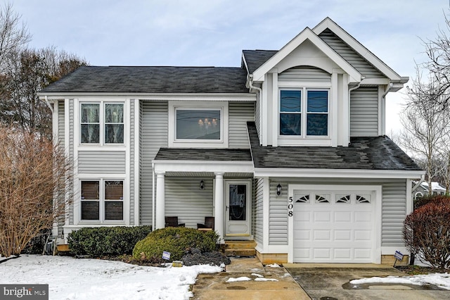 view of front of house featuring a garage and roof with shingles