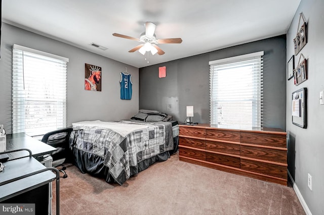 bedroom featuring baseboards, carpet, visible vents, and a ceiling fan