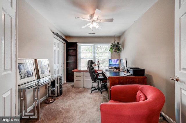 carpeted office space with visible vents and ceiling fan