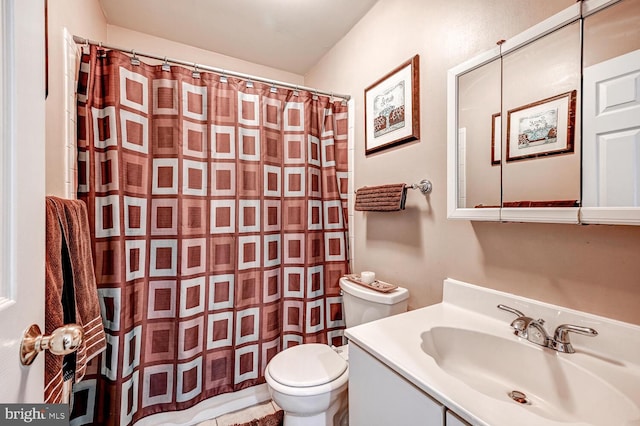 bathroom with curtained shower, vanity, and toilet