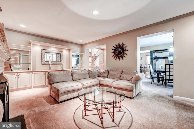 living area featuring recessed lighting, ornamental molding, baseboards, and light colored carpet