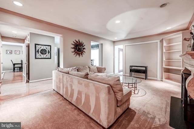 living room with ornamental molding, a fireplace, and baseboards