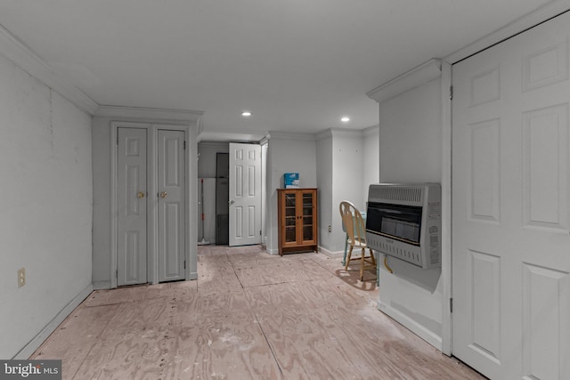 unfurnished living room with heating unit, a glass covered fireplace, crown molding, and recessed lighting