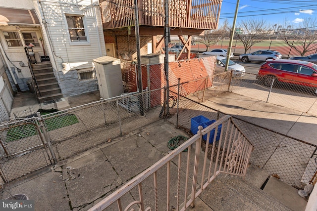 view of side of home with a fenced front yard and a gate