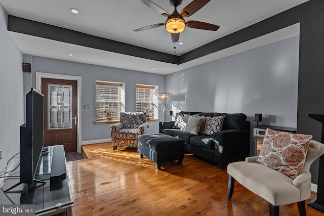 living area with ceiling fan, baseboards, wood finished floors, and recessed lighting