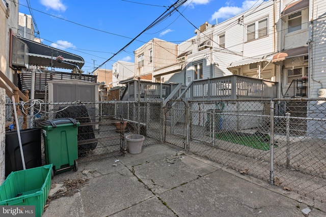 exterior space with fence private yard, a shed, a gate, and an outdoor structure