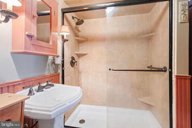 full bath featuring a stall shower and a sink