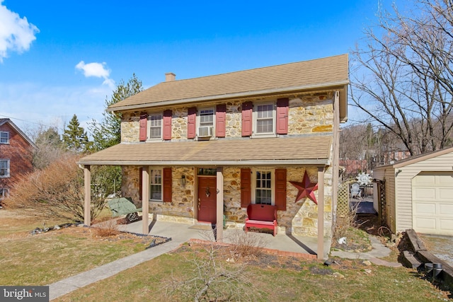 view of front of house featuring a porch, cooling unit, stone siding, and a chimney