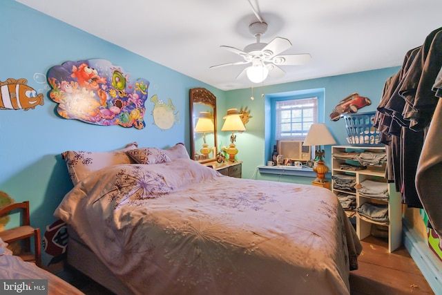 bedroom featuring a ceiling fan and cooling unit