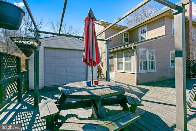 wooden terrace with an outbuilding and a garage