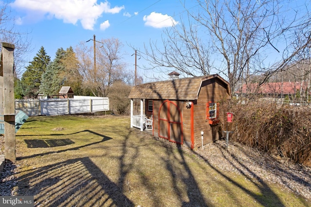 view of yard featuring an outdoor structure and fence