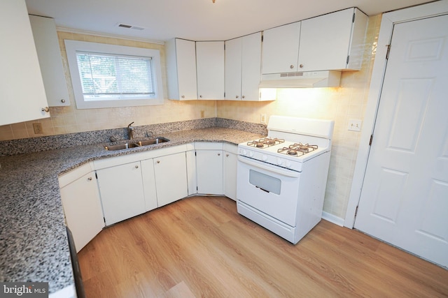 kitchen featuring white gas range, a sink, light wood-style flooring, and under cabinet range hood