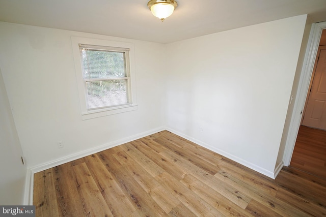 empty room featuring baseboards and wood finished floors