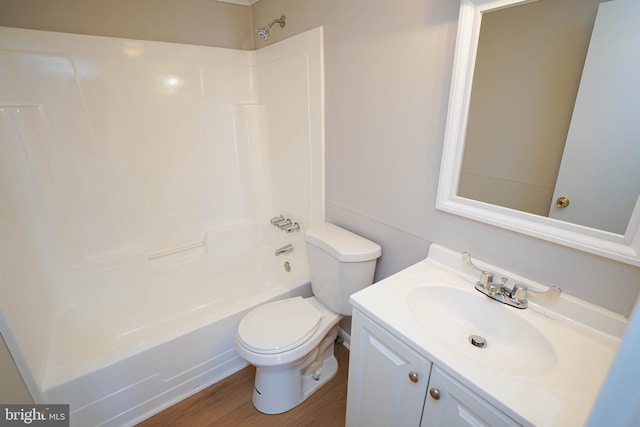 full bath featuring toilet, vanity, wood finished floors, and bathing tub / shower combination