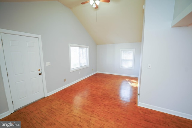 bonus room with lofted ceiling, ceiling fan, baseboards, and wood finished floors