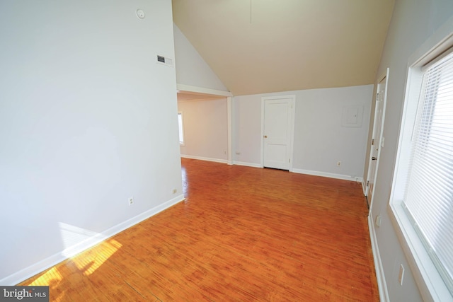 spare room with a wealth of natural light, light wood finished floors, visible vents, and baseboards