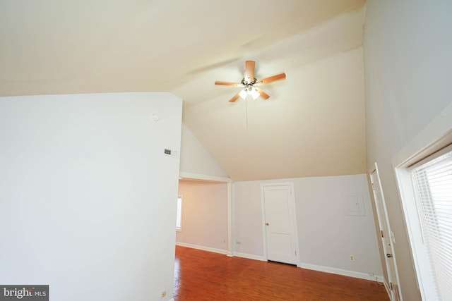 bonus room featuring lofted ceiling, a wealth of natural light, baseboards, and wood finished floors