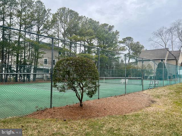 view of sport court featuring fence