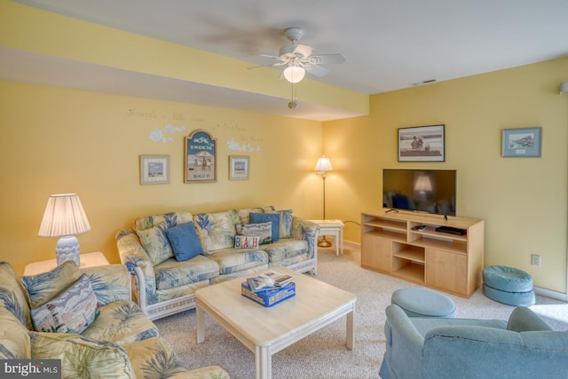 living room with carpet, baseboards, visible vents, and ceiling fan