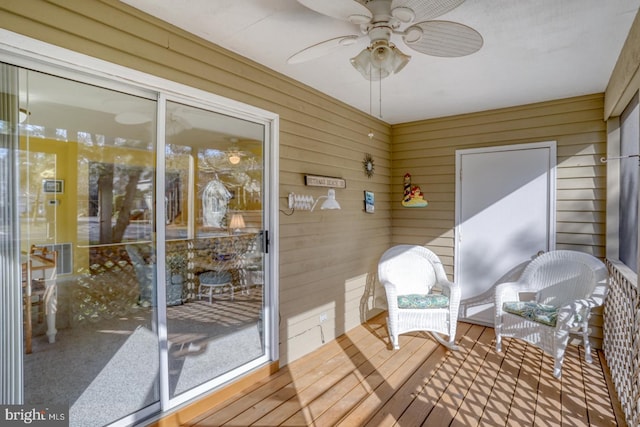 sunroom featuring ceiling fan