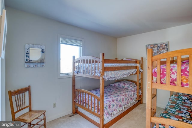 bedroom with baseboards and carpet