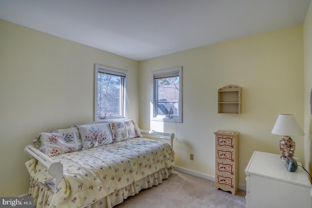 bedroom with baseboards and light carpet