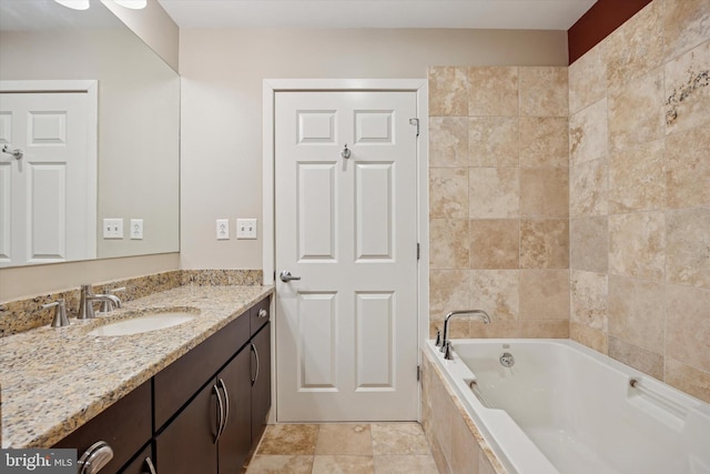 bathroom with tiled bath and vanity