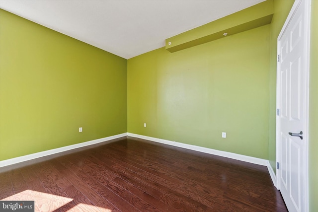 unfurnished room featuring dark wood finished floors and baseboards