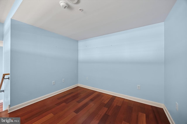 empty room featuring baseboards and wood finished floors