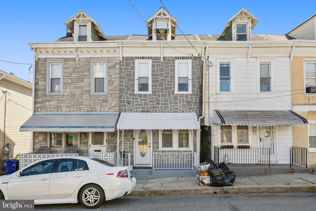 view of property featuring stone siding