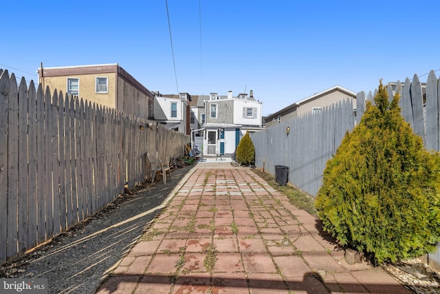 view of home's community featuring a fenced backyard and an outbuilding