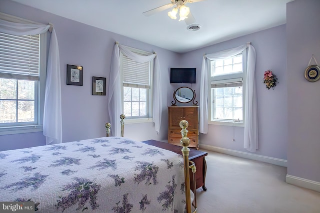 bedroom with carpet, visible vents, baseboards, and a ceiling fan