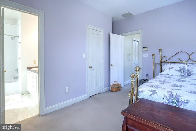 bedroom featuring baseboards and ensuite bathroom