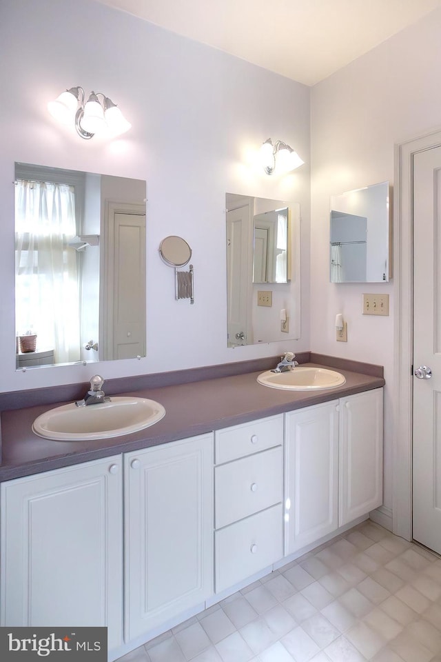 full bathroom featuring a sink and double vanity