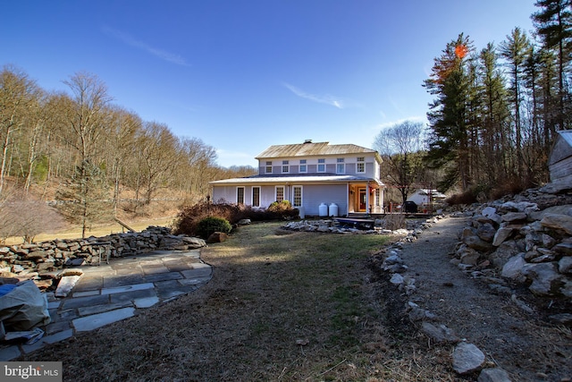 back of house featuring a patio and a lawn