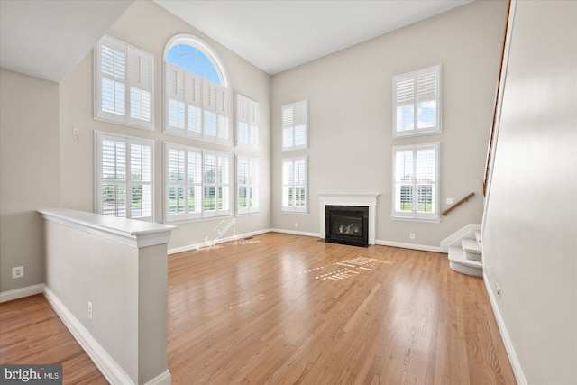 unfurnished living room featuring light wood-style floors and baseboards