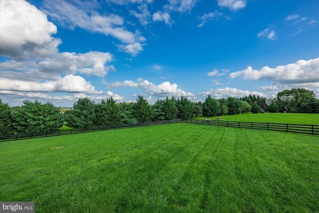 view of yard featuring a rural view and fence