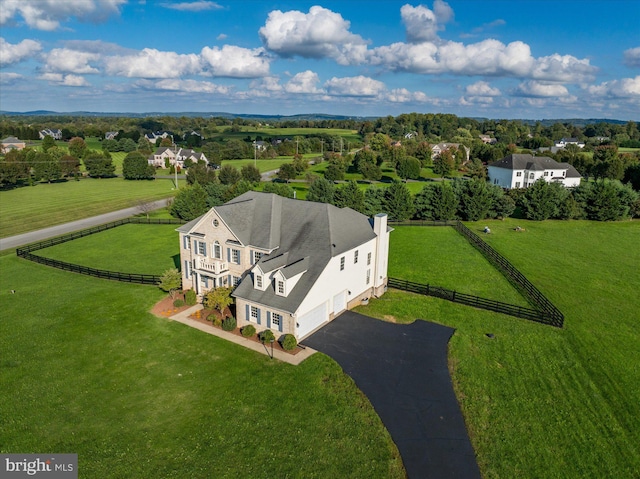 birds eye view of property with a rural view