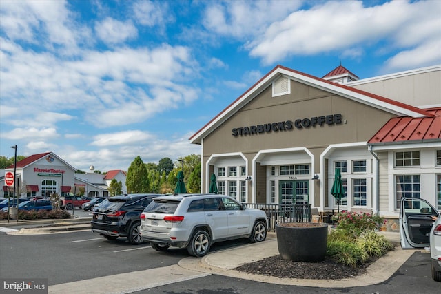 view of building exterior featuring uncovered parking