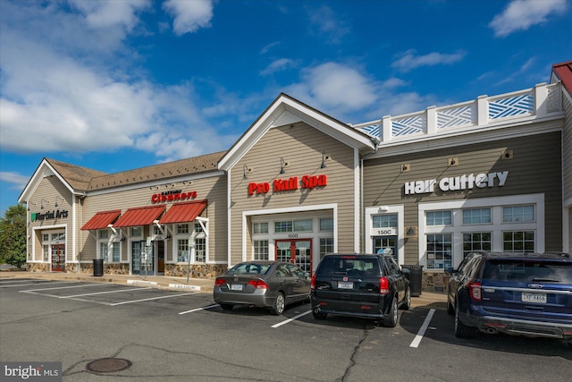 view of building exterior with uncovered parking