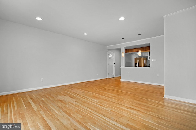 unfurnished living room featuring recessed lighting, light wood-style flooring, and baseboards