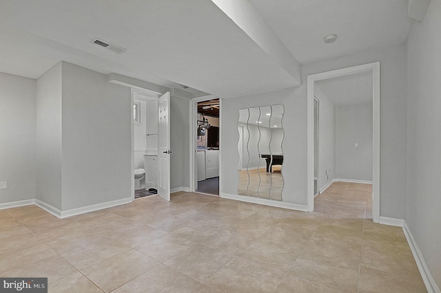 interior space with visible vents, baseboards, and separate washer and dryer