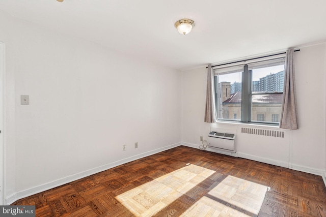 empty room featuring baseboards and a wall mounted air conditioner