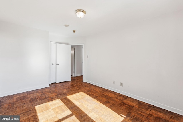 empty room featuring baseboards