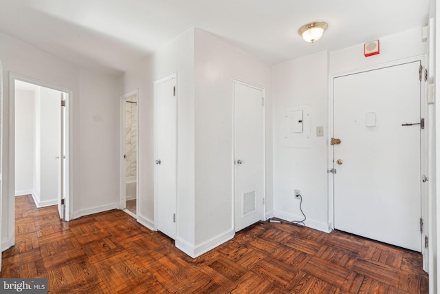 foyer entrance with baseboards and visible vents