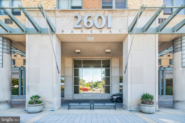 doorway to property featuring brick siding