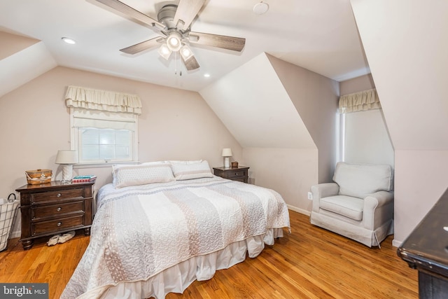 bedroom featuring lofted ceiling, baseboards, wood finished floors, and recessed lighting